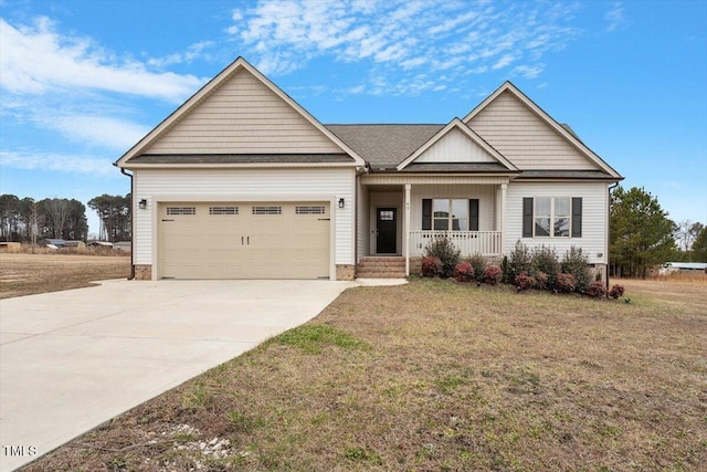 craftsman house with covered porch, a front yard, and a garage