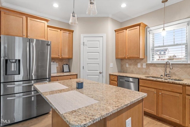 kitchen with a center island, appliances with stainless steel finishes, sink, ornamental molding, and backsplash