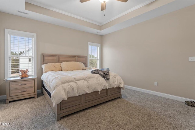 bedroom featuring carpet, multiple windows, ceiling fan, and a raised ceiling