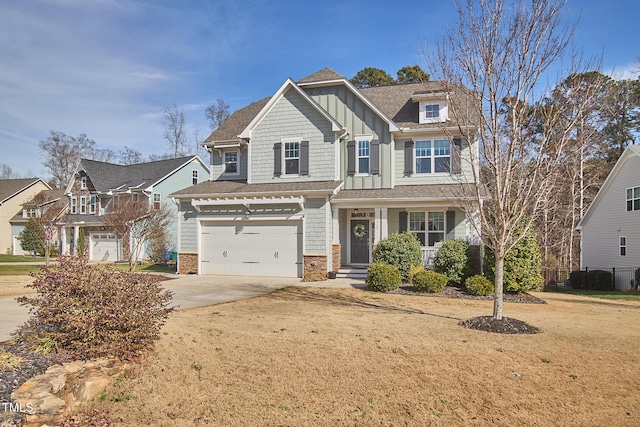 craftsman-style house with a garage, a front lawn, board and batten siding, and concrete driveway