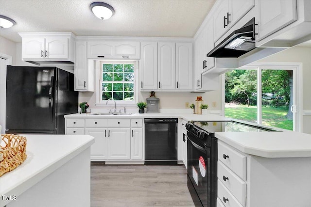 103 Val Del Ct, Garner, NC 27529 - kitchen featuring black appliances, a sink, under cabinet range hood, white cabinets, and a textured ceiling