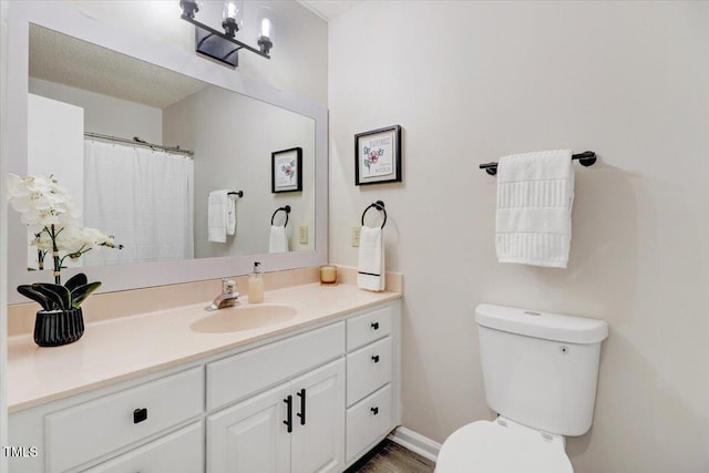 103 Val Del Ct, Garner, NC 27529 - full bath featuring vanity, toilet, baseboards, and wood finished floors