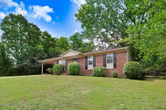 103 Val Del Ct, Garner, NC 27529 - ranch-style house with brick siding, a front lawn, and an attached carport
