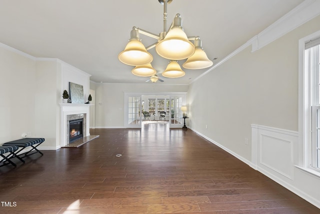 unfurnished living room with crown molding, a premium fireplace, and dark hardwood / wood-style floors