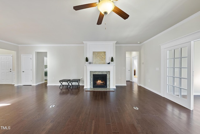 unfurnished living room featuring crown molding, ceiling fan, a premium fireplace, and dark hardwood / wood-style flooring