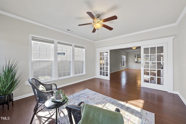 sitting room featuring crown molding, dark wood-type flooring, ceiling fan, and french doors