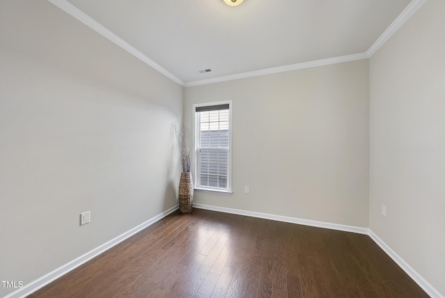 spare room featuring dark wood-type flooring and ornamental molding