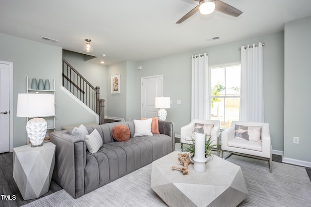 living room featuring hardwood / wood-style floors and ceiling fan