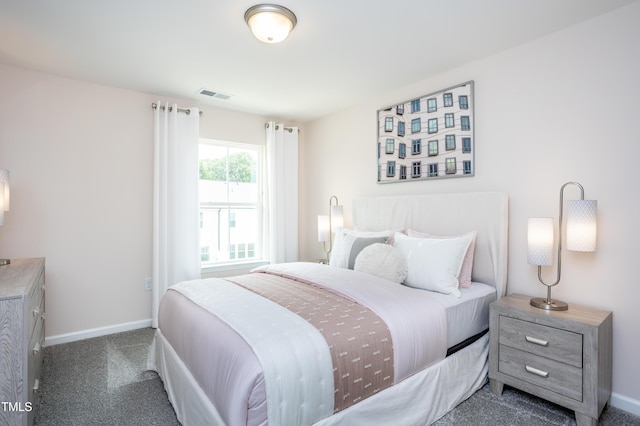 bedroom featuring dark carpet