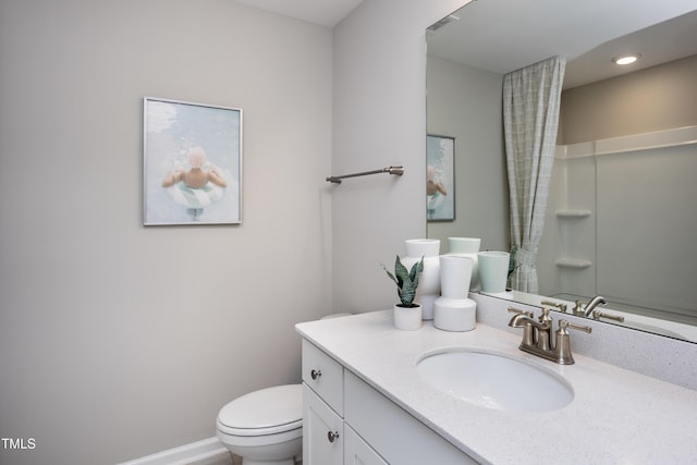 bathroom with vanity, toilet, and walk in shower