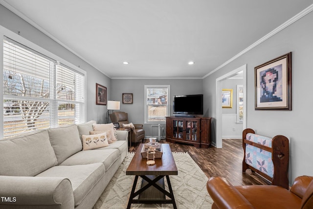 living room with crown molding, a healthy amount of sunlight, and dark hardwood / wood-style floors