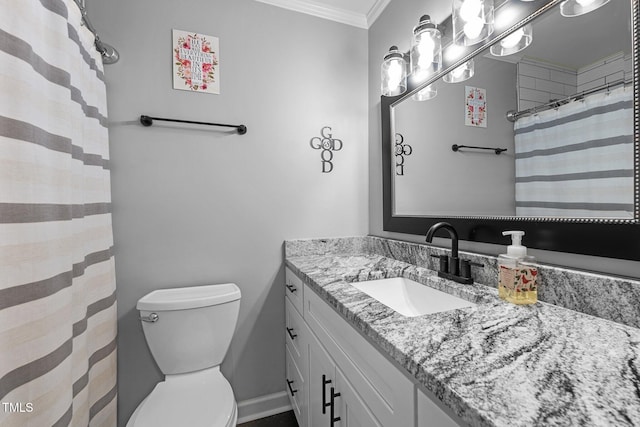 bathroom featuring crown molding, vanity, and toilet