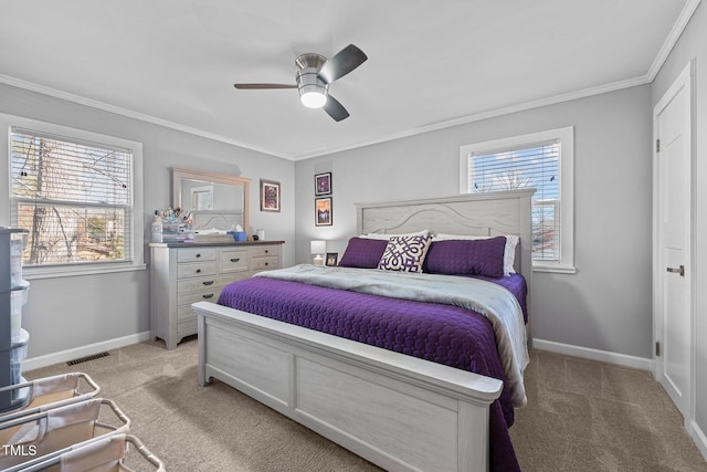 bedroom with ceiling fan, multiple windows, light carpet, and crown molding