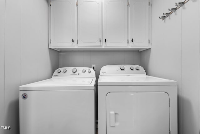 washroom with independent washer and dryer and cabinets