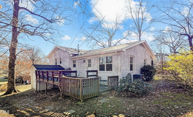 back of house with a wooden deck and central AC unit