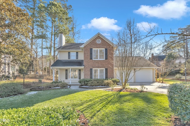 view of front facade featuring a front yard, a garage, and covered porch