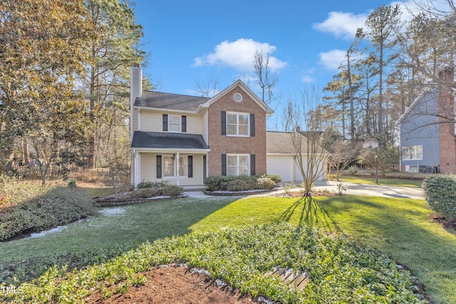 view of front of house featuring a front yard, a garage, and covered porch