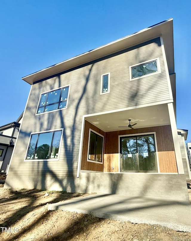 back of property featuring ceiling fan