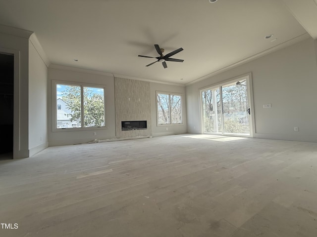 unfurnished living room featuring light hardwood / wood-style flooring, crown molding, and a fireplace