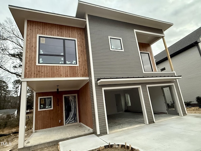 rear view of property featuring a garage