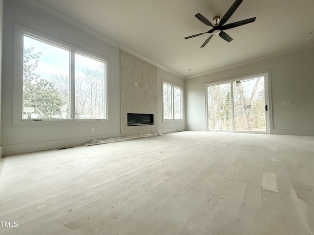 unfurnished living room with a fireplace, ornamental molding, light hardwood / wood-style floors, and ceiling fan