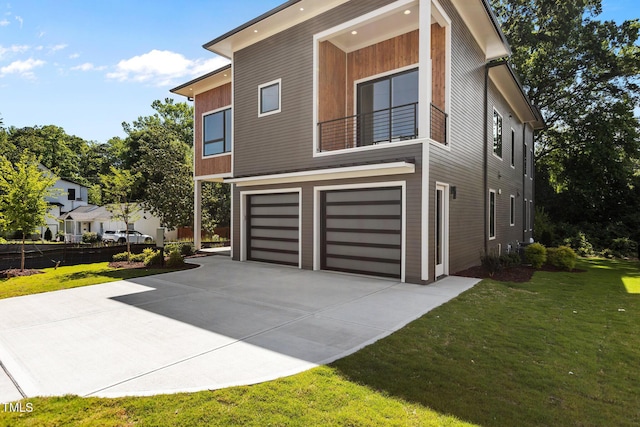 view of property exterior featuring a lawn, driveway, and a garage