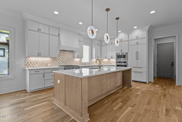 kitchen featuring stainless steel appliances, crown molding, tasteful backsplash, light countertops, and light wood finished floors