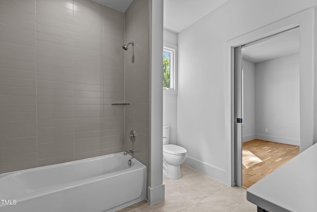 full bathroom featuring toilet, tub / shower combination, baseboards, and tile patterned floors