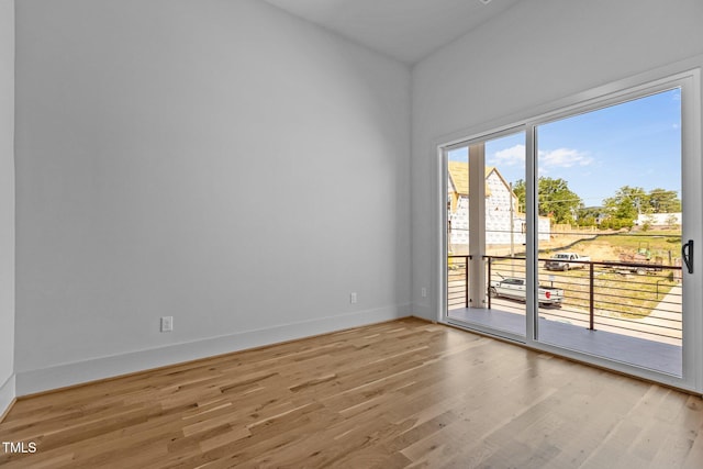 empty room featuring wood finished floors and baseboards