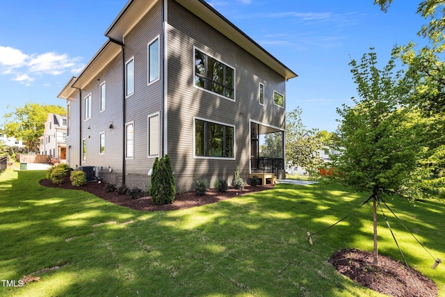 view of property exterior featuring a yard and cooling unit