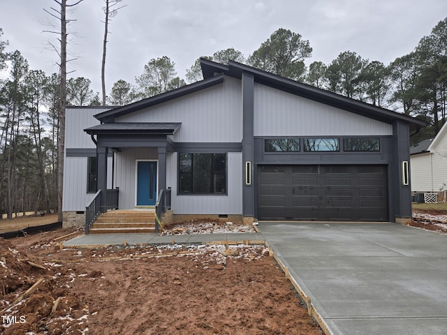 view of front of house with crawl space, a garage, and driveway