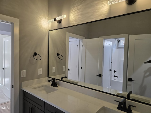 bathroom featuring double vanity and a sink