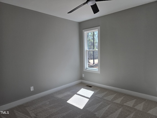 spare room featuring visible vents, baseboards, carpet, and ceiling fan