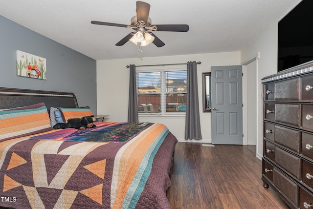 bedroom with ceiling fan and dark hardwood / wood-style floors