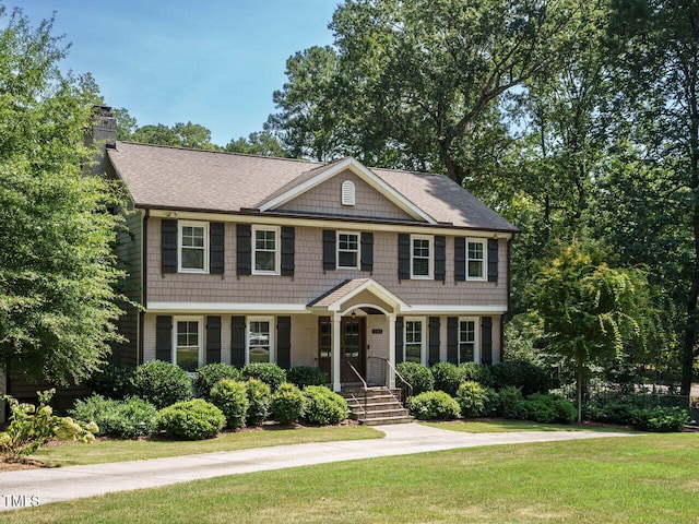 colonial home with a front lawn