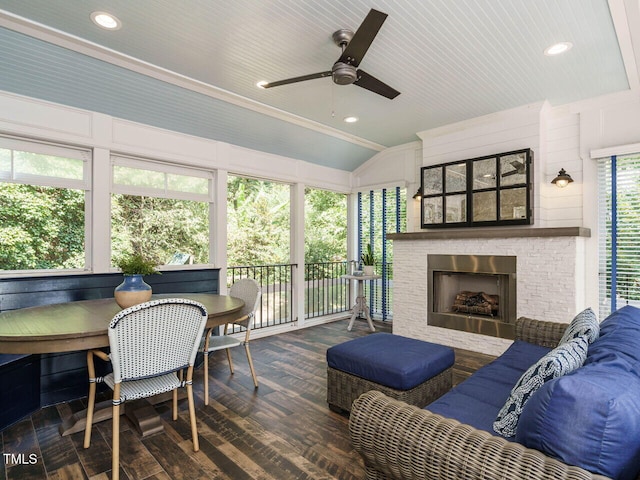 exterior space featuring vaulted ceiling, a fireplace, and ceiling fan