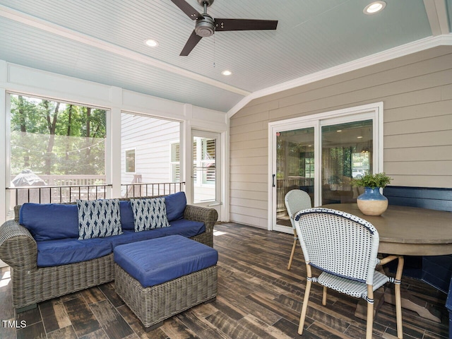 sunroom / solarium featuring lofted ceiling and ceiling fan