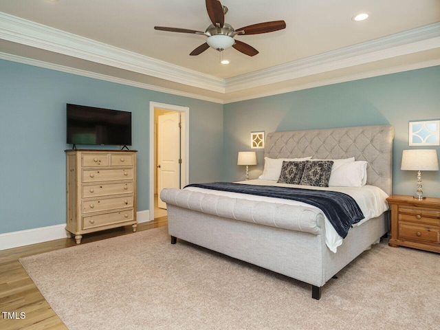 bedroom with ceiling fan, light hardwood / wood-style floors, and ornamental molding