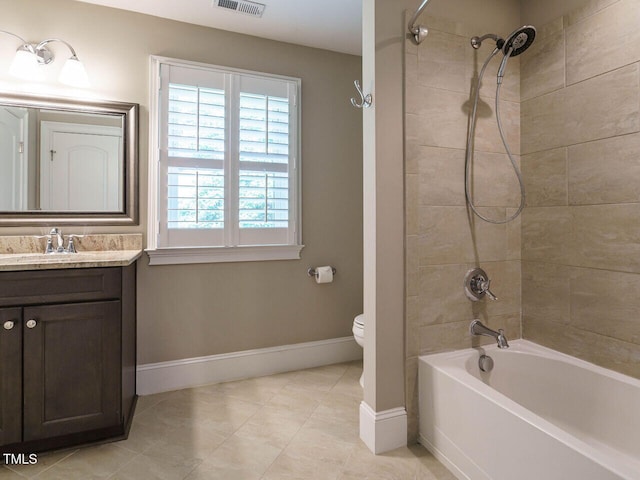 full bathroom with toilet, tiled shower / bath, and vanity