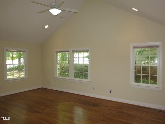 empty room with high vaulted ceiling, dark hardwood / wood-style flooring, and ceiling fan