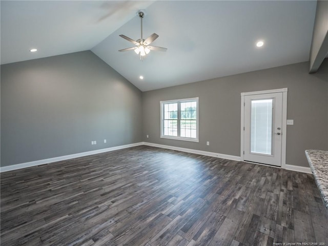 empty room with lofted ceiling, ceiling fan, and dark hardwood / wood-style floors