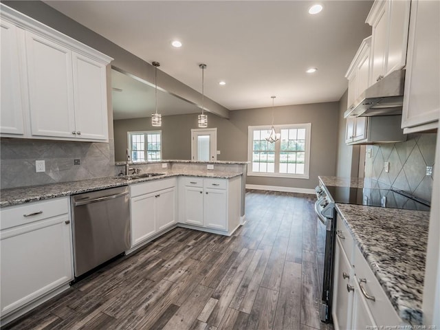 kitchen featuring stainless steel appliances, sink, white cabinets, light stone countertops, and pendant lighting