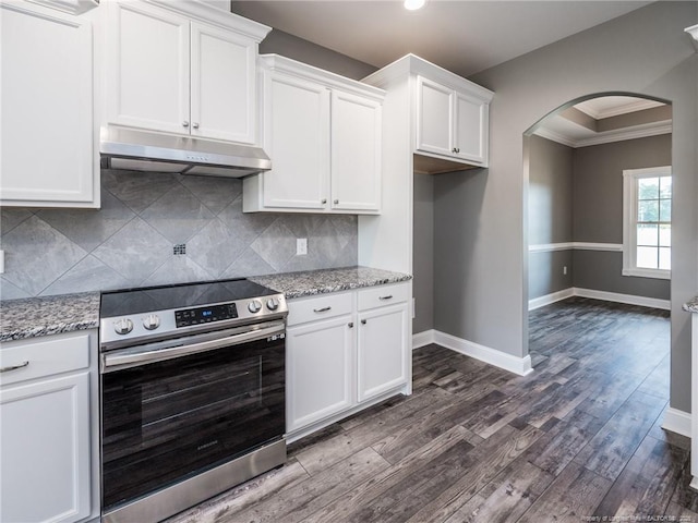 kitchen with light stone counters, white cabinets, and stainless steel range with electric stovetop