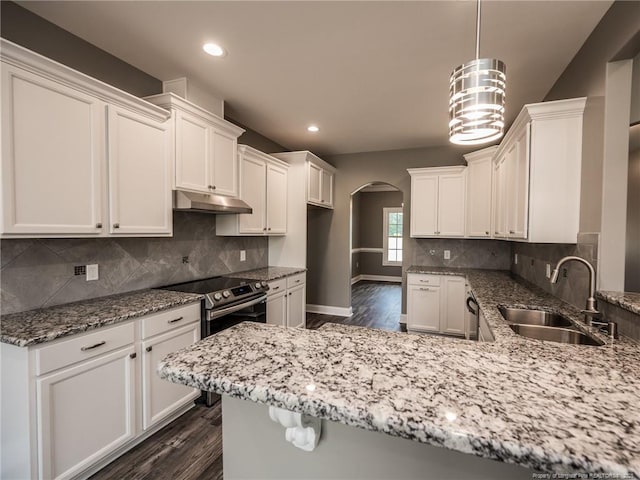 kitchen featuring sink, stainless steel electric range oven, white cabinets, and decorative light fixtures