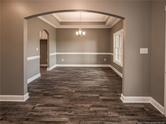 unfurnished dining area with a tray ceiling, crown molding, and dark hardwood / wood-style floors