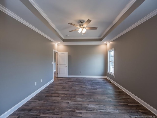 unfurnished room featuring ceiling fan, a tray ceiling, crown molding, and dark hardwood / wood-style floors