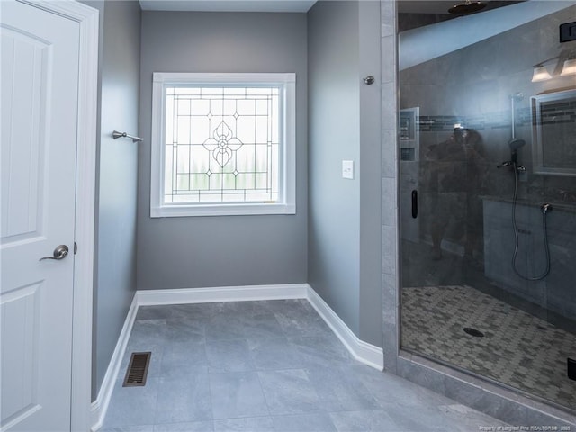 bathroom featuring a shower with door