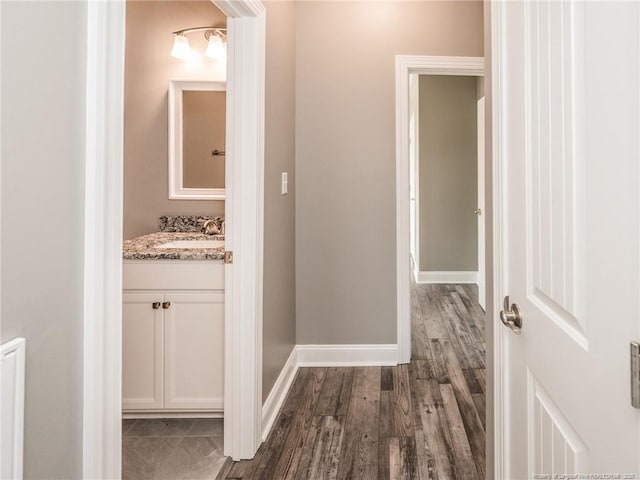 interior space with vanity and wood-type flooring