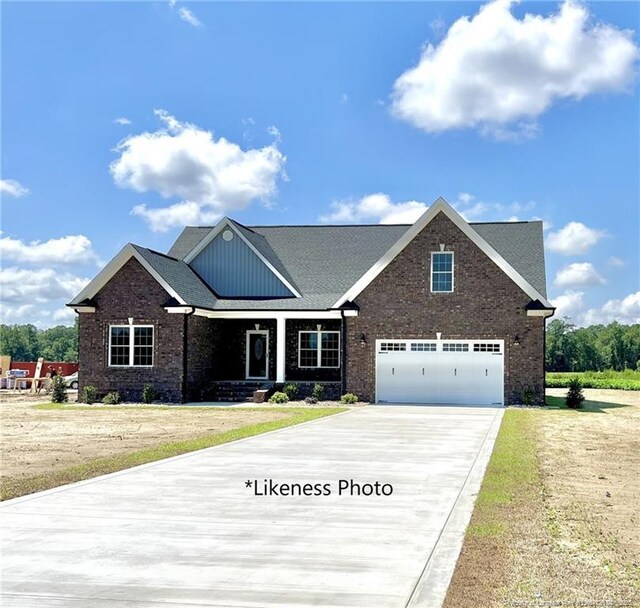 831 Norment Rd, Lumberton, NC 28360 - craftsman-style home with covered porch, concrete driveway, a front yard, and brick siding