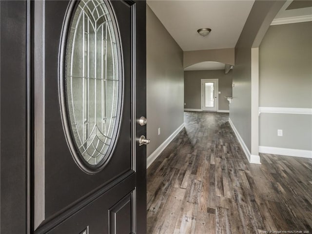 831 Norment Rd, Lumberton, NC 28360 - foyer entrance featuring arched walkways, baseboards, and dark wood finished floors